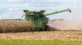 A John Deere combine harvesting a crop field