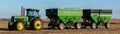 A John Deere farm tractor parked in a field