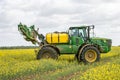 John Deere R4040i sprayer spraying in RSO field Royalty Free Stock Photo