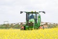 John Deere R4040i sprayer spraying in RSO field Royalty Free Stock Photo