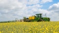 John Deere R4040i sprayer spraying in RSO field Royalty Free Stock Photo