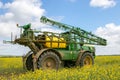 John Deere R4040i sprayer spraying in RSO field Royalty Free Stock Photo