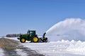 John Deere 6145R tractor blowing snow