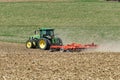 John Deere 8400R tractor pulling a Kuhn Excelerator 8000 tiller