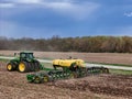 John Deere 410 8R tractor pulling a John Deere 1775NT 24 row planter Royalty Free Stock Photo