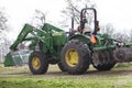 John Deere Tractor with bucket and disk in springtime