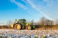 John deere tractor cutting hedges in snow