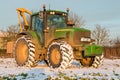 John deere tractor cutting hedges in snow