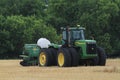 John Deere Tractor with a Great plains drill on the back for planting sitting in a wheat stubble farm field in Kansas.
