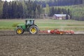John Deere Tractor and Harrow Working in Field
