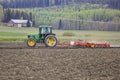 John Deere Tractor and Harrow Working in Field