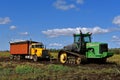 John Deere tractor pulling beet truck in the mud