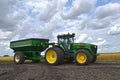 John Deere 7920 tractor pulling a gravity grain box