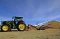 John Deere tractor Tube elevator transfers soybeans