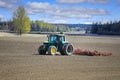 John Deere Tractor and Vaderstad Tine Harrow in Field