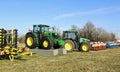 John Deere tractors with attachments and implements on display outside the official dealership. Royalty Free Stock Photo