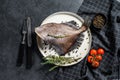 John Dory fish with pink pepper and thyme. Black background. Top view Royalty Free Stock Photo
