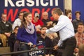 John Kasich speaks with a young supporter