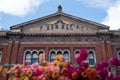 The John Madejski Garden at the Victoria and Albert Museum, London UK. Photo shows facade of Lecture Theatre with flowers in front