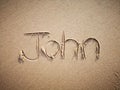 A John name written on the beach.