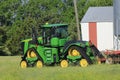 Johndeere Tractor with a Disc on the back shot closeup in a field. Royalty Free Stock Photo