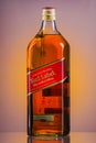 Johnnie Walker Red Label blended whisky on gradient background.