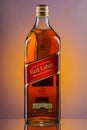 Johnnie Walker Red Label blended whisky on gradient background.