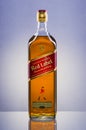 Johnnie Walker Red Label blended whisky on gradient background.