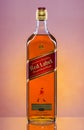 Johnnie Walker Red Label blended whisky on gradient background.