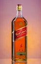 Johnnie Walker Red Label blended whisky on gradient background.