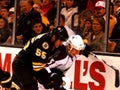 Johnny Boychuk and Cody McLeod battle for the puck Royalty Free Stock Photo