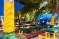 JOHNNY CAY, COLOMBIA - OCTOBER 21, 2017: Close up of some typical wooden tables with the color of colombian flag