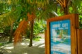 JOHNNY CAY, COLOMBIA - OCTOBER 21, 2017: Informative sign under a palm trees in Johnny Cay, Island of San Andres