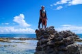 JOHNNY CAY, COLOMBIA - OCTOBER 21, 2017: Unidentified blonde woman enjoying the beautiful sunny day over a rock in the