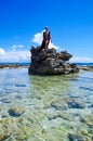JOHNNY CAY, COLOMBIA - OCTOBER 21, 2017: Unidentified blonde woman enjoying the beautiful sunny day over a rock in the
