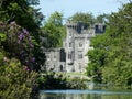 Johnstown Castle in County Wexford, Ireland,  surrounded by a lake and lush gardens in sunlight Royalty Free Stock Photo