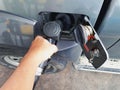 JOHOR, MALAYSIA - AUGUST 9, 2017: A hand holding diesel fuel pump nozzle during refilling fuel into the car tank. Royalty Free Stock Photo