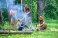 Join summer picnic. Friends meeting near bonfire to hang out and prepare roasted sausages snacks nature background