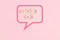Join us message on wooden cubes framed by a speech bubble on pink background Royalty Free Stock Photo