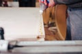 Joiner applies glue for gluing wooden planks