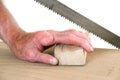 Joiner without one finger sawing a piece of wood Royalty Free Stock Photo