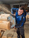 Joiner sawing wood with a chainsaw Royalty Free Stock Photo