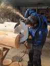 Joiner sawing wood with a chainsaw Royalty Free Stock Photo