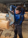 Joiner sawing wood with a chainsaw Royalty Free Stock Photo