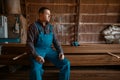 Joiner in uniform at his workplace on timber mill