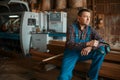 Joiner in uniform at his workplace on timber mill