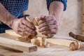 Joiners hands with woodworkers plane in work