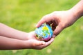 Joining forces to take care of global. Blurred green lawn background. Protect our globe. Royalty Free Stock Photo