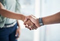 Joining forces will be a game changer. two unrecognizable businesspeople standing in the office together and shaking Royalty Free Stock Photo