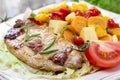 Joint of pork with baked potatoes and fresh vegetables Royalty Free Stock Photo